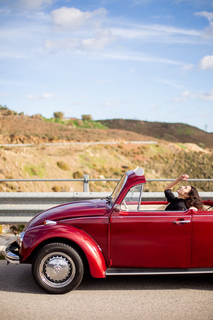 classic-red-convertible-on-scenic-road-adventure-35534501